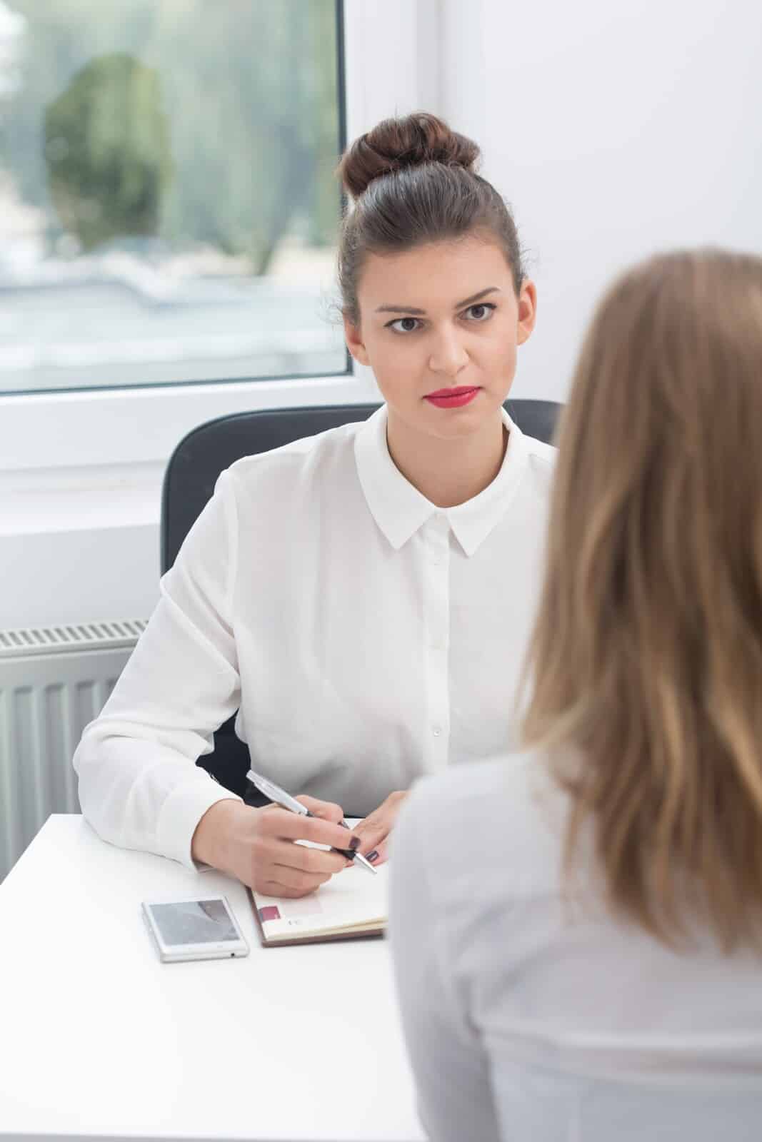 stern supervisor discussing with employee disciplinary action process